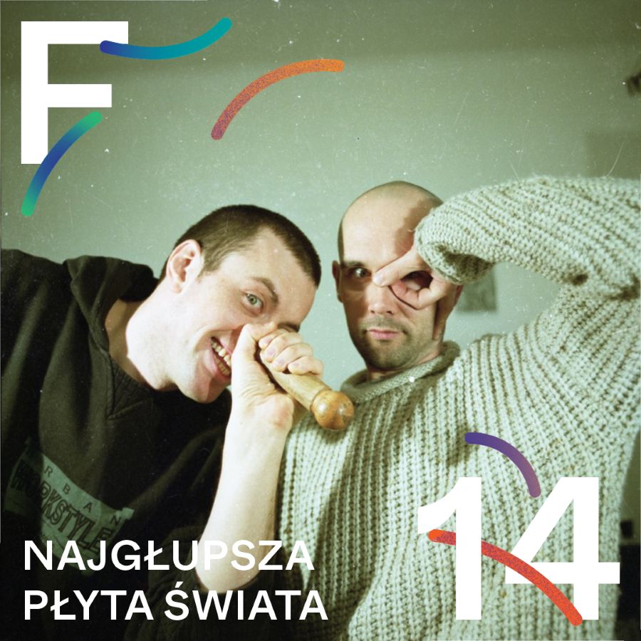 dwóch mężczyzn łysych, jeden z bluzie polarowej, drugi w jasnym swetrze. jeden trzyma drewniany instrument przy nosie, drugi układa palce wokół oczu.