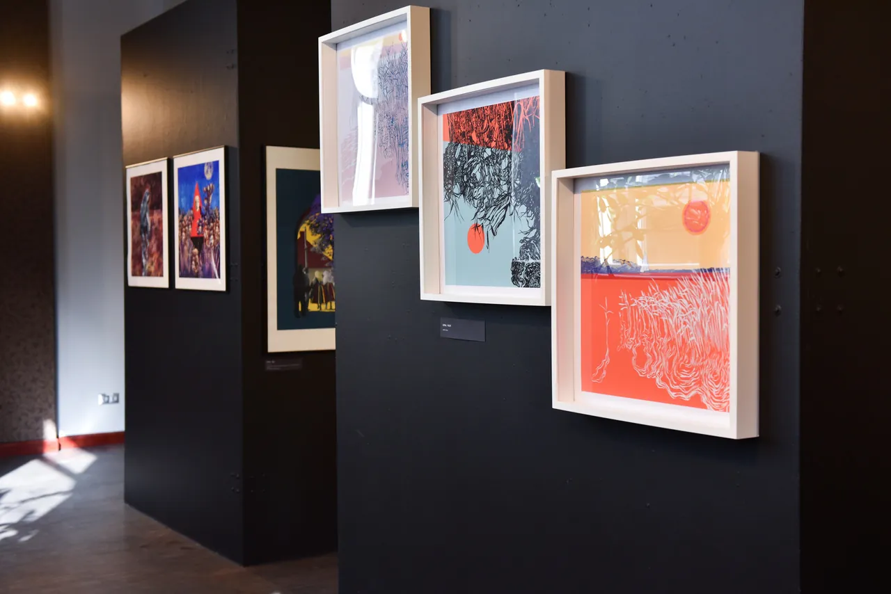 The photo shows a wall on which three framed graphics hang.